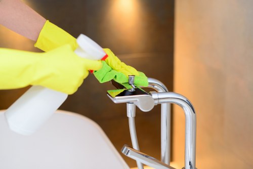 Local technician cleaning a sectional sofa in Maidavale apartment