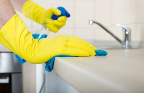 Professional domestic cleaner working in a Maidavale family home bedroom