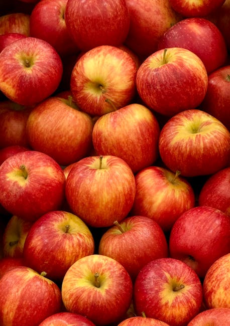 A close-up view of numerous red apples with yellow streaks, piled together in a basket or container, displaying smooth, shiny surfaces. The apples vary slightly in size and coloration, some with visible stems, and are set against a plain background. The scene highlights the fresh, clean appearance of the fruit, with no visible dirt or blemishes, emphasizing a sense of hygiene and quality. This image exemplifies the importance of surface cleaning and maintenance, similar to domestic and commercial cleaning practices promoted by Carpet Cleaners Maida Vale, especially in relation to adhering to waste management rules and hygiene standards in the Maida Vale area.